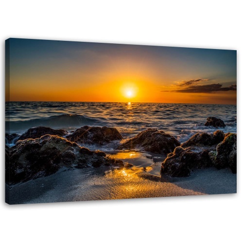 Obraz na plátně Západ slunce na kamenité pláži